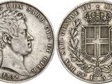 a silver coin with a crown on top of it