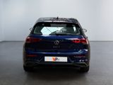 the back of a blue vw golf parked in a room