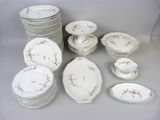 a lot of plates and bowls that are sitting on a table