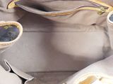 a purse that has a pair of shoes inside of it