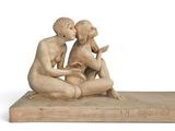 statue of a man and a woman sitting on a wooden base