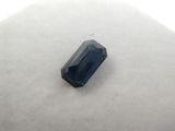 a close up of a blue sapphire stone on a white surface