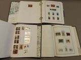 four open books with stamps on them sitting on a table