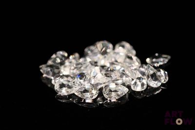a pile of diamonds sitting on a black surface