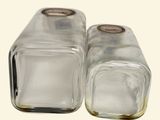 pair of clear glass salt and pepper shakers on a white background