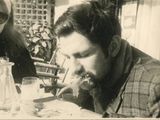 two people sitting at a table eating food together