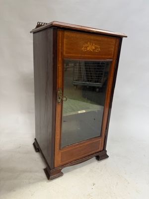 a small wooden cabinet with a glass door on it
