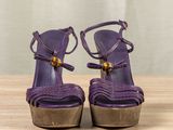 purple high heeled sandals with a wooden heel and a wooden platform