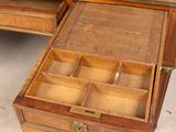 a wooden desk with a black top and drawers