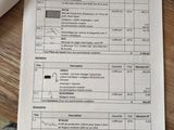 a person sitting at a table with a calculator and papers