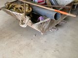 a wheelbarrow that is sitting in a garage filled with tools