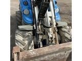 a tractor that is sitting in the back of a truck