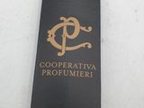 a black neck tie with a gold logo on it