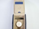 a box with a watch inside of it on a white surface