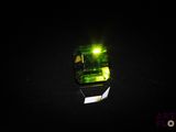 a green light that is shining in the dark