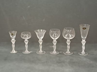 six wine glasses lined up on a table