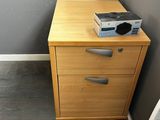an image of a nightstand with a computer on top of it