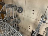 a metal shopping cart that is sitting on the floor