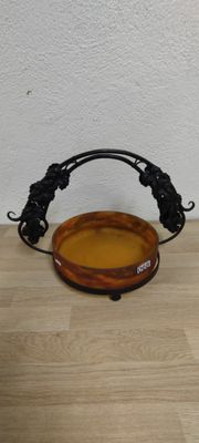 a brown bowl with a handle on a wooden table