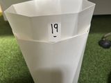 a white vase with a number on it sitting on a green carpet