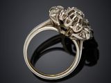 a close up of a diamond ring on a black surface