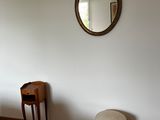a mirror on the wall above a bed in a bedroom