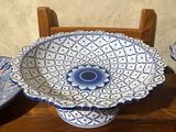 three blue and white plates on a wooden table