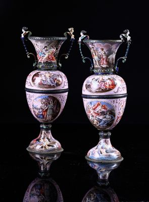 two vases that are sitting on a black surface