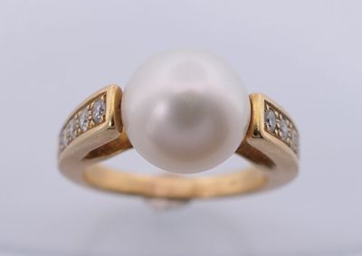 a white pearl and diamond ring on a white background