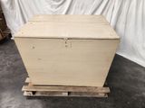 a wooden box sitting on top of a pallet in a warehouse