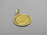 a close up of a gold coin on a silver surface