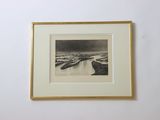an old photo of a river in a frame hanging on a wall