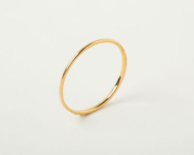 a close up of a gold ring on a white surface
