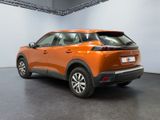 the rear end of an orange suv parked in a garage