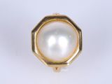 a close up of a ring with a pearl inside of it