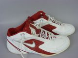 pair of white and red sneakers with white laces on a gray surface