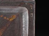 a brown plate with a design on it sitting on a table
