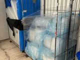 a metal cage filled with plastic containers and a blue container