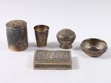 an image of a group of metal objects sitting on top of a white surface