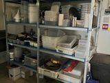 a kitchen with a shelf full of pots and pans