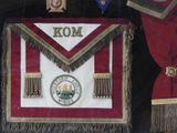a red and white apron with a gold emblem on it