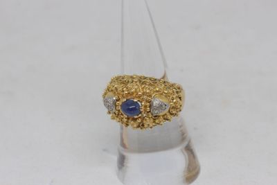 an image of a diamond and sapphire ring on a clear surface