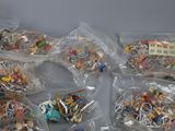 a lot of small toys in plastic bags on the table