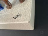 a figurine of a horse on a white plate