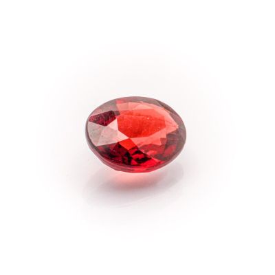a close up of a red garnet stone on a white background
