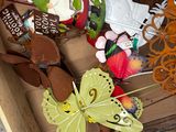 a wooden box filled with different types of paper butterflies