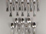 a lot of silver spoons and spoon spoons on the table
