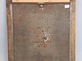 a picture of a rusted picture frame on a white wall