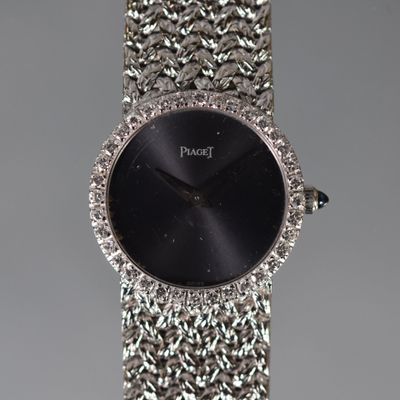an image of a close up of a wrist watch with a black face
