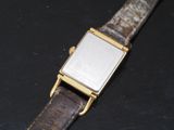 a watch that is sitting on a black surface